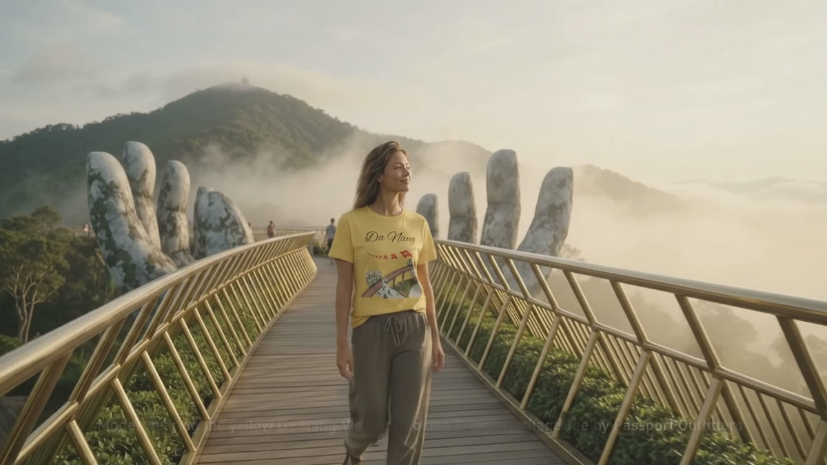 Model wearing the yellow Da Nang Vietnam Golden Bridge Heritage Tee by Passport Outfitters